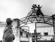 Советские бойцы сбивают фашистскую свастику с входа на территорию завода им.Войкова в освобожденном городе Керчи. Апрель  1944 г.